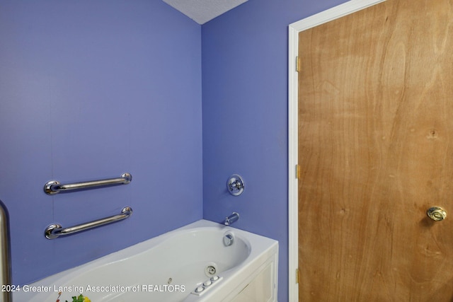 bathroom featuring a bathtub and a textured ceiling