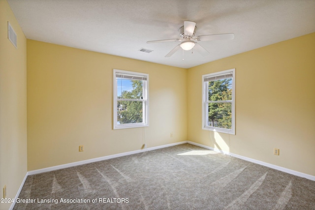 unfurnished room with carpet floors, ceiling fan, and a healthy amount of sunlight