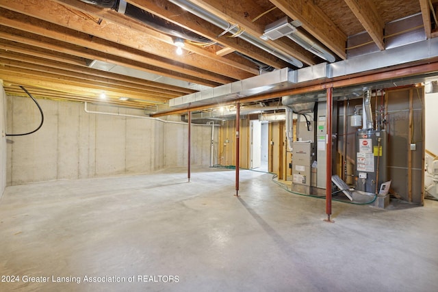 basement with gas water heater and heating unit