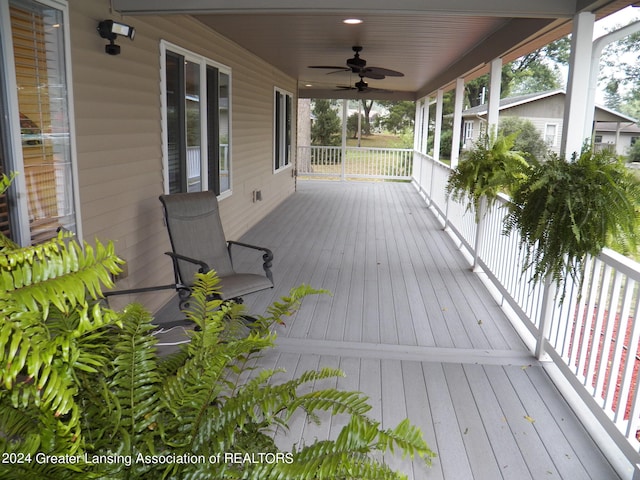 wooden terrace featuring ceiling fan