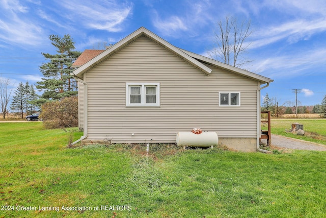 view of home's exterior with a yard