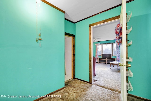 hall featuring carpet flooring and crown molding