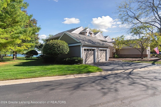 view of home's exterior featuring a lawn and a garage