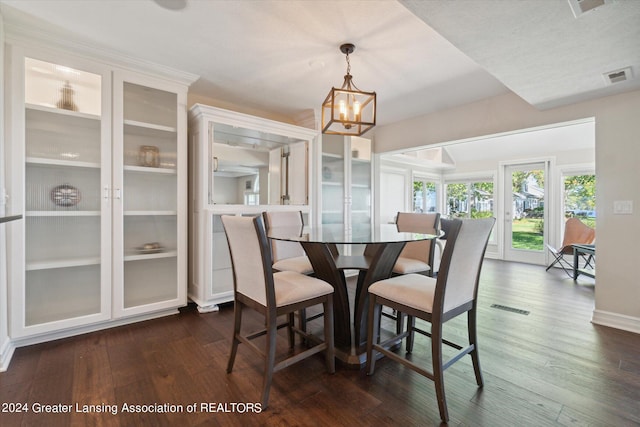 dining room featuring a notable chandelier and dark hardwood / wood-style floors