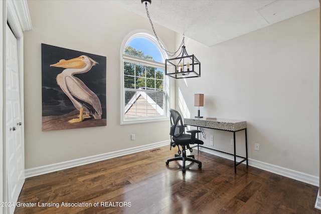 home office with an inviting chandelier, a textured ceiling, and dark hardwood / wood-style flooring