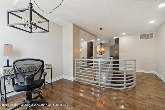 office area featuring a notable chandelier, dark hardwood / wood-style flooring, and a textured ceiling