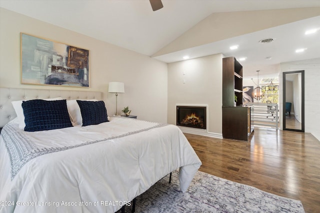 bedroom with vaulted ceiling, hardwood / wood-style floors, and ceiling fan