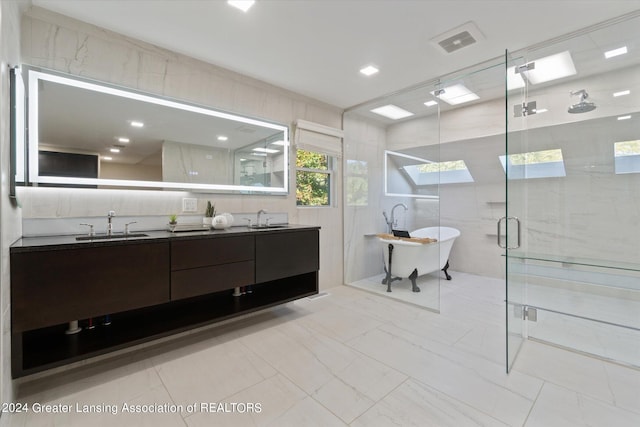 bathroom with tile walls, vanity, and separate shower and tub