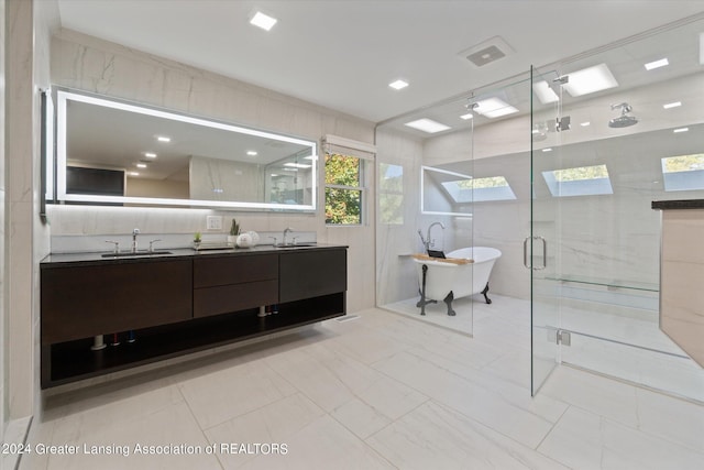 bathroom with tile walls, vanity, and separate shower and tub