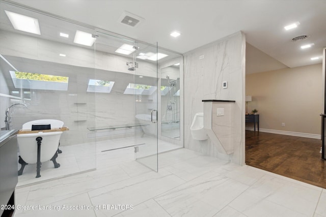 bathroom with independent shower and bath and hardwood / wood-style flooring