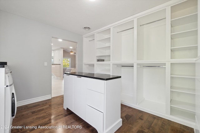 walk in closet featuring ceiling fan, dark hardwood / wood-style flooring, and washer / dryer