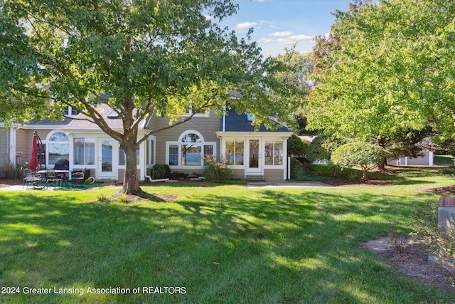 view of front of home with a patio and a front lawn