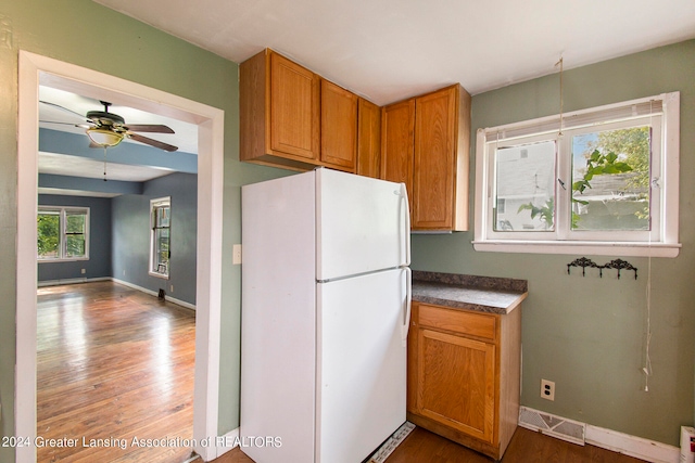 kitchen featuring ceiling fan, white refrigerator, and hardwood / wood-style floors