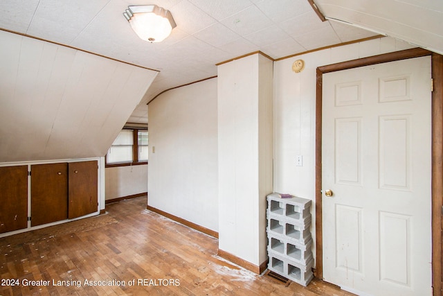 bonus room featuring wood-type flooring and vaulted ceiling