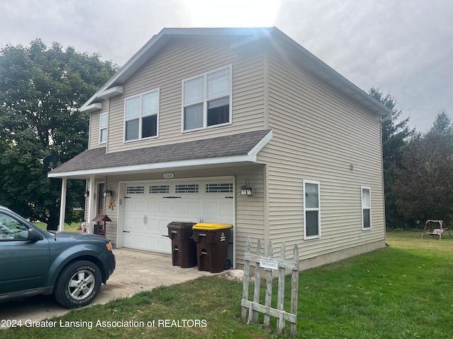 view of side of home with a yard and a garage