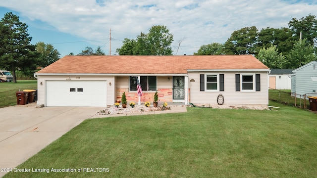 view of front of home featuring a garage and a front yard