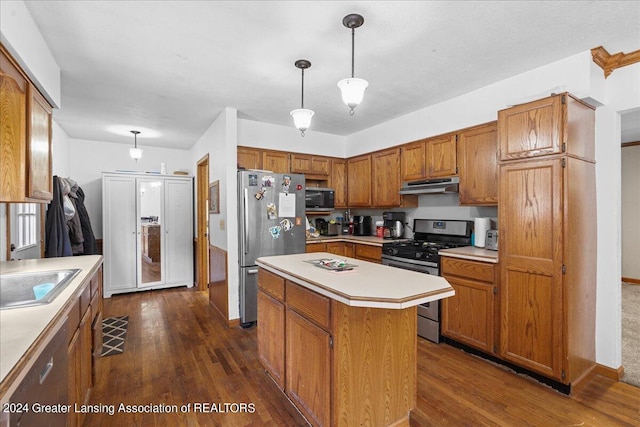 kitchen with a kitchen island, dark hardwood / wood-style flooring, stainless steel appliances, decorative light fixtures, and sink