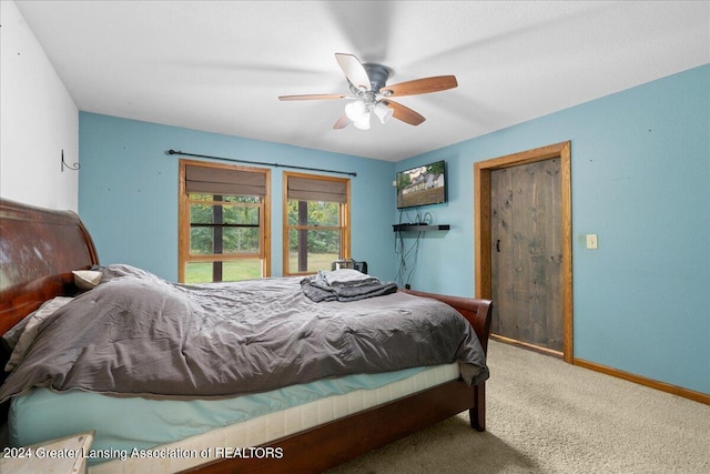 bedroom with ceiling fan and carpet flooring