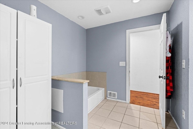 bathroom featuring tile patterned flooring and a bathing tub