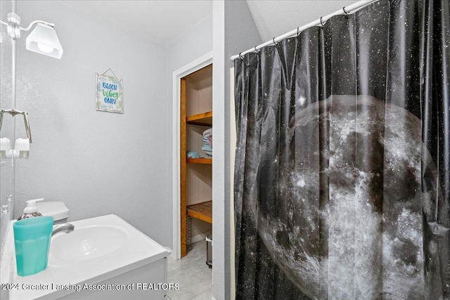 bathroom featuring a shower with shower curtain, vanity, and tile patterned floors