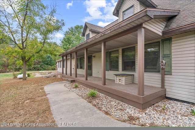 view of side of home featuring covered porch