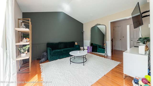 living room featuring vaulted ceiling and hardwood / wood-style floors