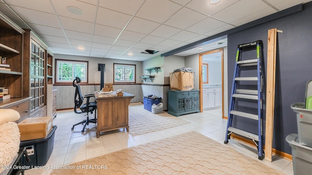 office space featuring a drop ceiling and light tile patterned floors