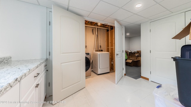 laundry area featuring light tile patterned floors and independent washer and dryer