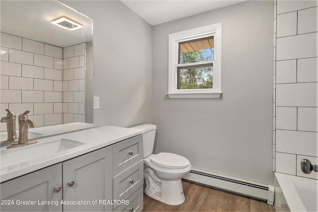 full bathroom with vanity, wood-type flooring, shower with separate bathtub, a baseboard radiator, and toilet