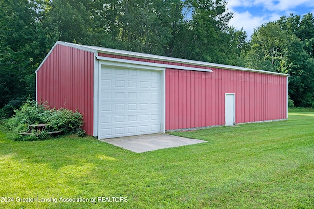 view of outbuilding featuring a garage and a yard