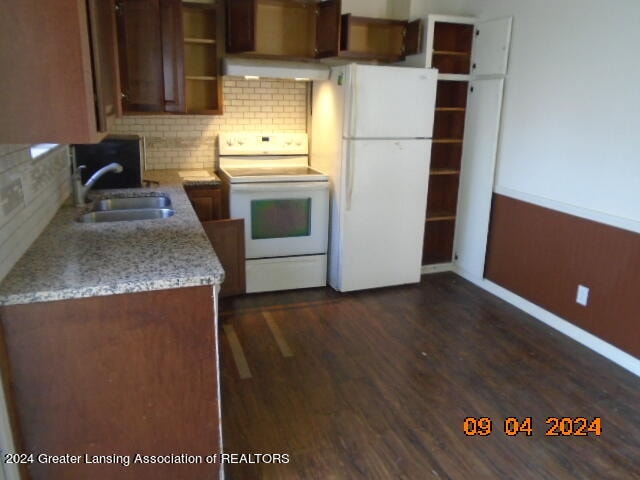 kitchen featuring dark hardwood / wood-style floors, tasteful backsplash, sink, white appliances, and extractor fan