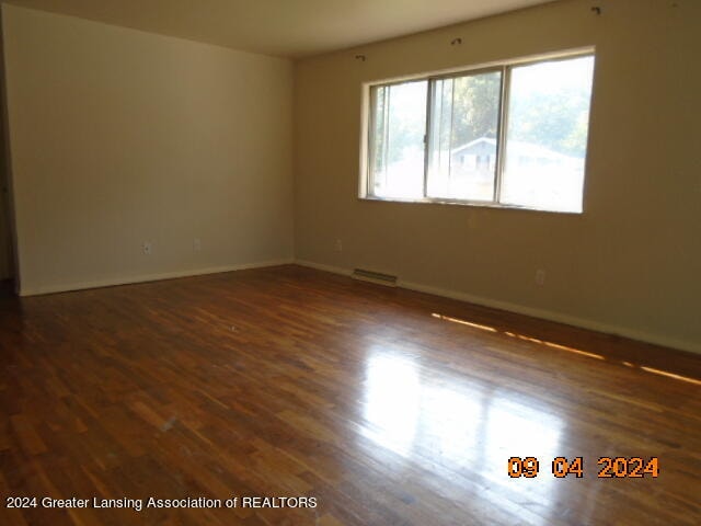 spare room with dark hardwood / wood-style flooring