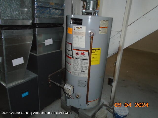 utility room featuring gas water heater