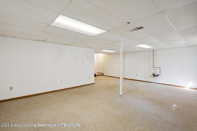 basement with carpet flooring and a drop ceiling