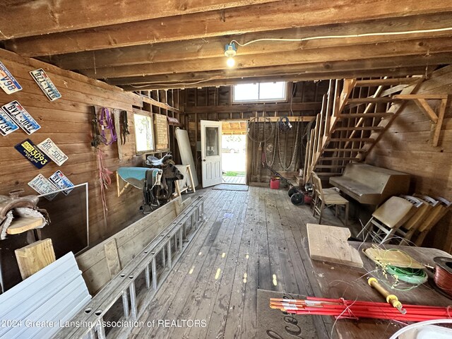 basement with wood-type flooring and wood walls