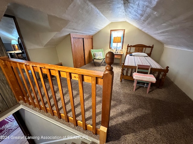 carpeted bedroom featuring lofted ceiling