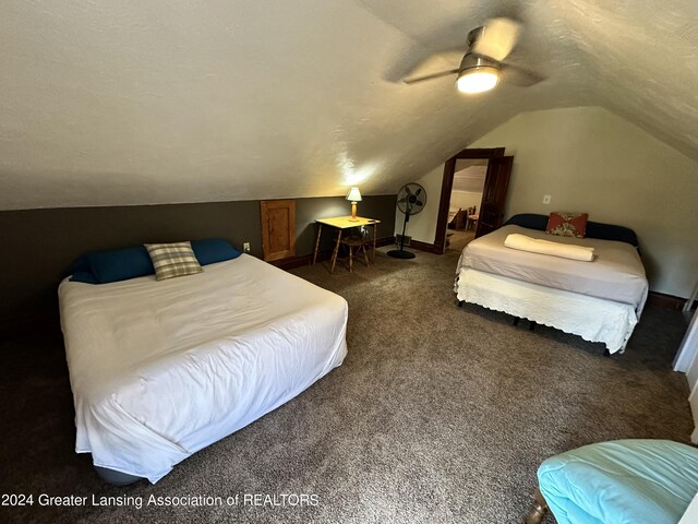 carpeted bedroom featuring ceiling fan, a textured ceiling, and lofted ceiling