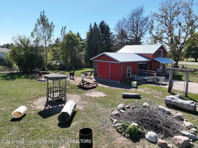 view of yard with an outdoor structure and a fire pit