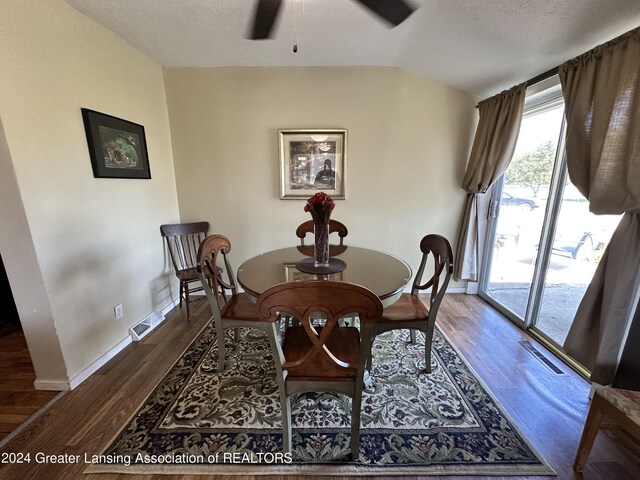 dining room featuring a textured ceiling, dark hardwood / wood-style flooring, and ceiling fan