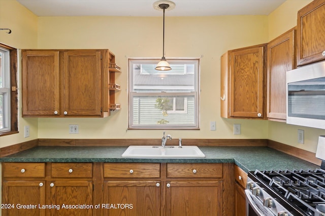 kitchen featuring sink, pendant lighting, and stainless steel appliances