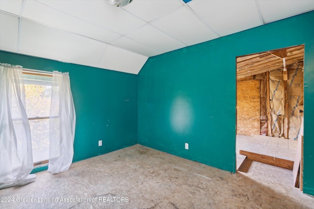 empty room featuring lofted ceiling