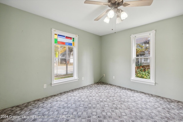 carpeted empty room with ceiling fan