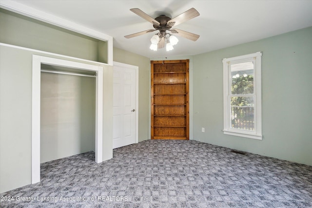 unfurnished bedroom featuring a closet, carpet floors, and ceiling fan