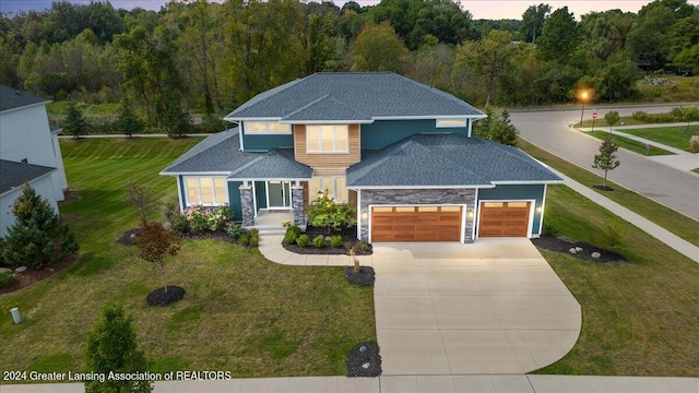 view of front of home featuring a garage and a yard