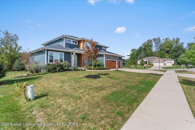 view of front of house featuring a garage and a front yard