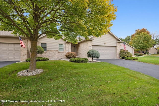 view of front of property with a front yard and a garage