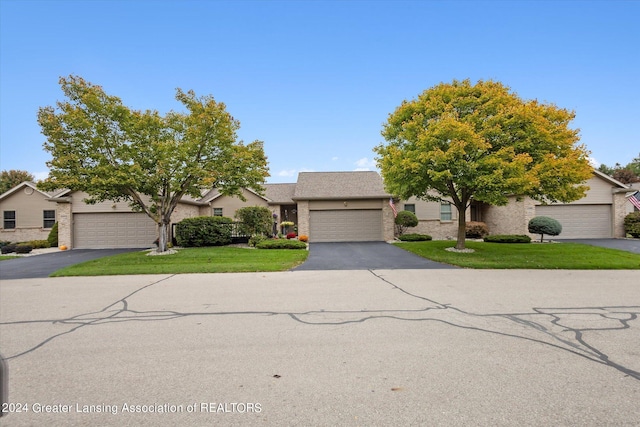 view of front of property with a garage and a front lawn