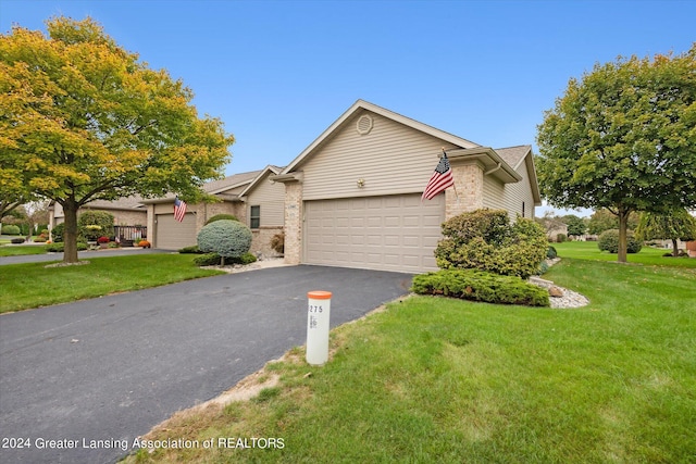 view of front of house featuring a garage and a front lawn