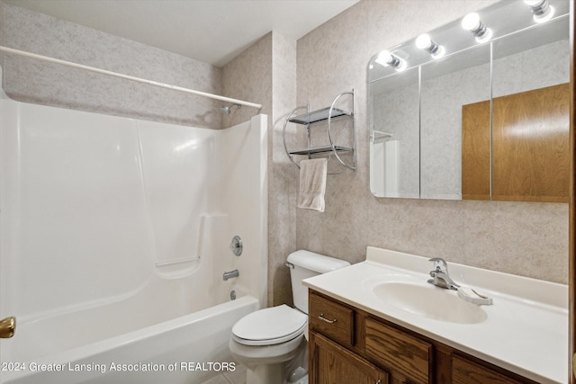 full bathroom with tub / shower combination, vanity, and toilet