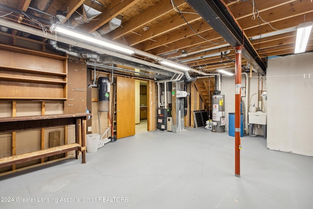 basement with water heater, sink, and heating unit